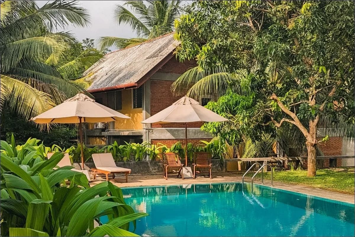 Best honeymoon hotels in Sri Lanka - a couple on a beautiful Sri Lankan beach at sunset with tropical palm trees