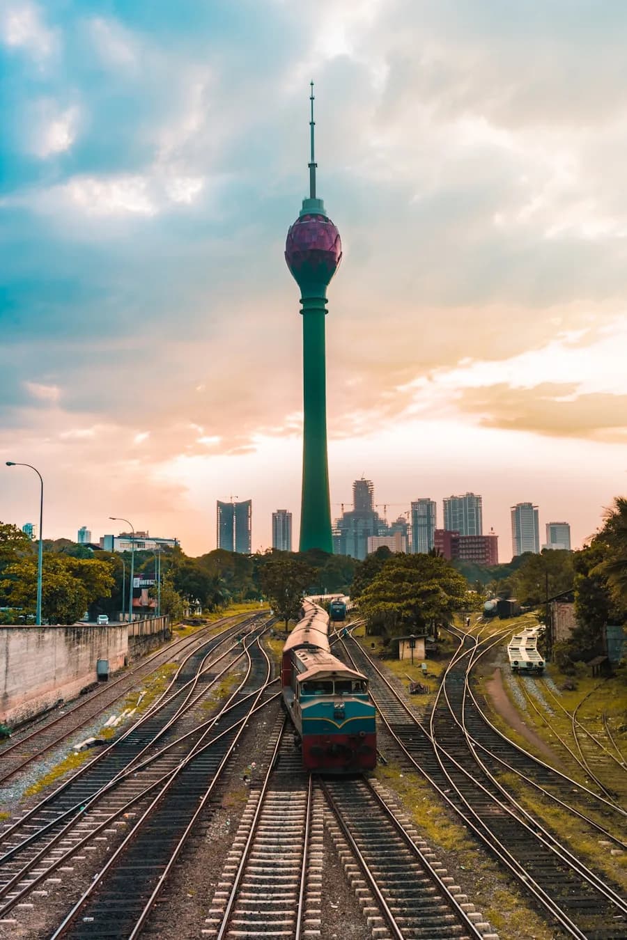 Lotus Tower Colombo with railway tracks and city skyline at sunset