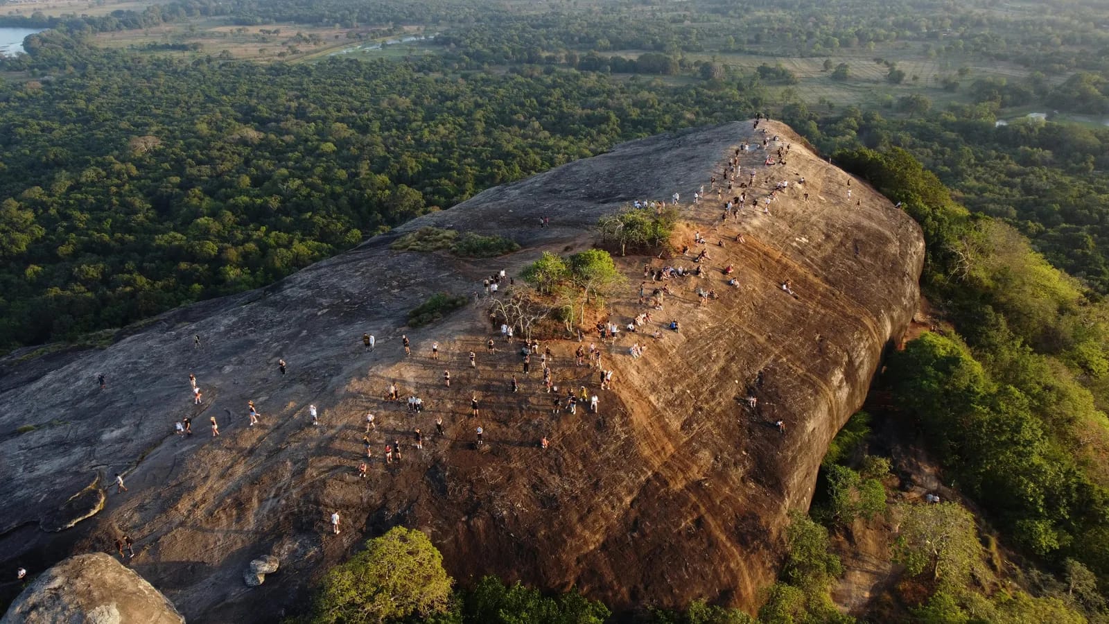 View from the summit of Pidurangala Rock looking across the jungle to Sigiriya Rock Fortress rising dramatically from the plain
