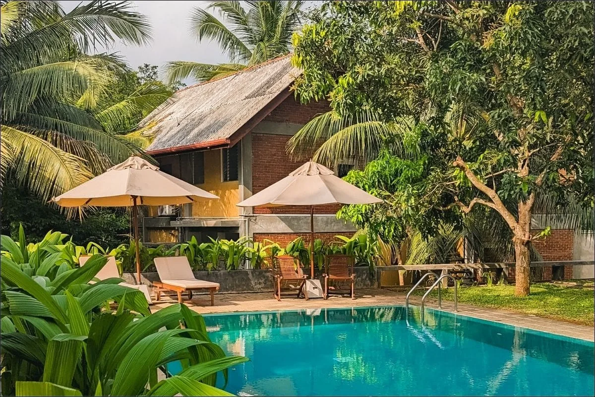 Best honeymoon hotels in Sri Lanka - a couple on a beautiful Sri Lankan beach at sunset with tropical palm trees