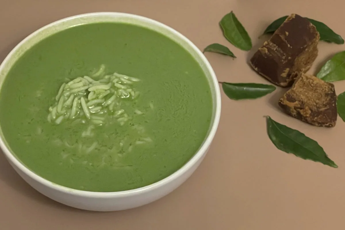 A bowl of vibrant green Kola Kanda Sri Lankan herbal rice porridge served warm with coconut milk