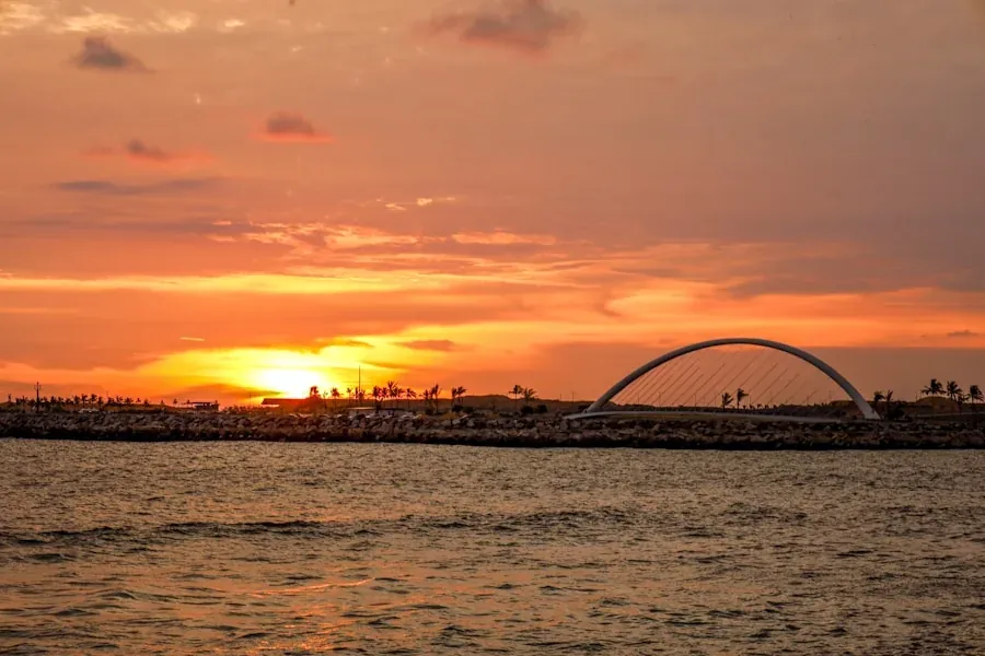 Galle Face Green promenade in Colombo with the Indian Ocean in the background at sunset, people walking and flying kites