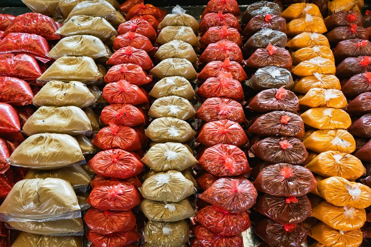 Colourful bags of spices at a Sri Lankan market - turmeric, chili, and aromatic spice blends