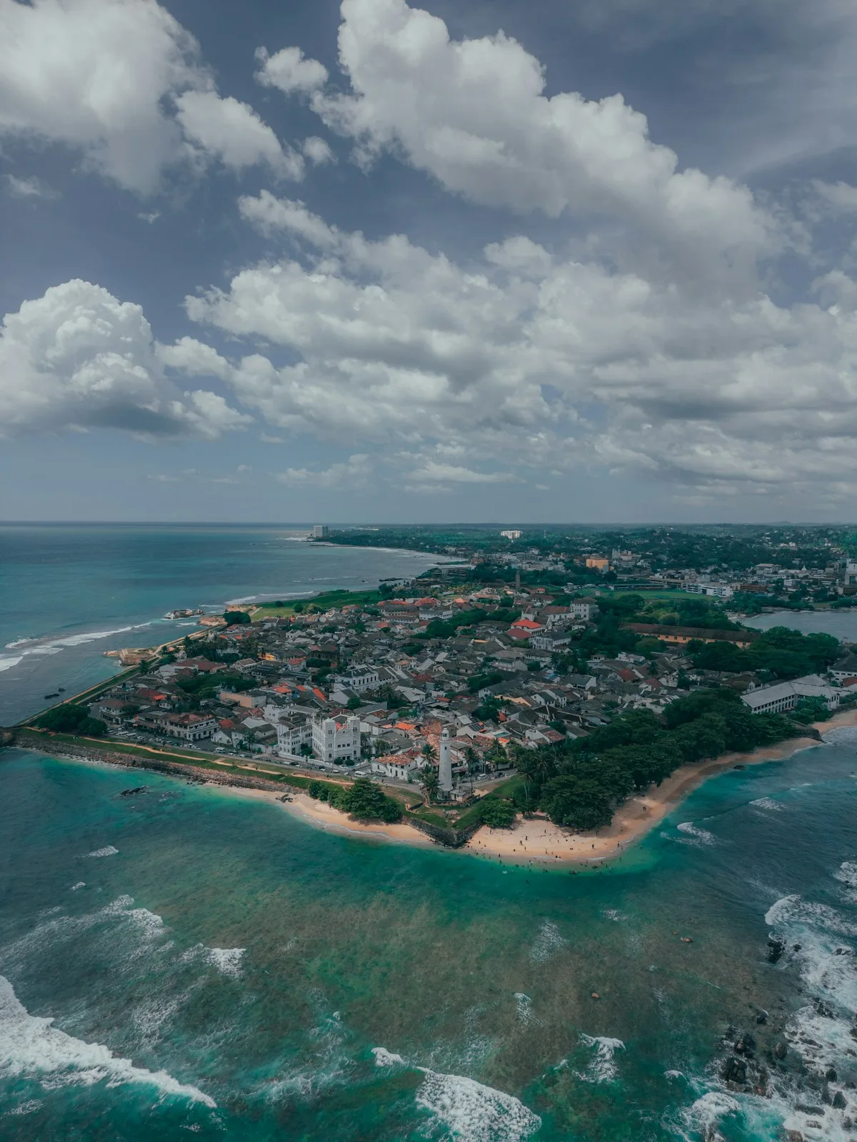 Clear turquoise water and white sand at Unawatuna beach on Sri Lanka's south coast under bright blue skies - idyllic but requiring awareness of currents
