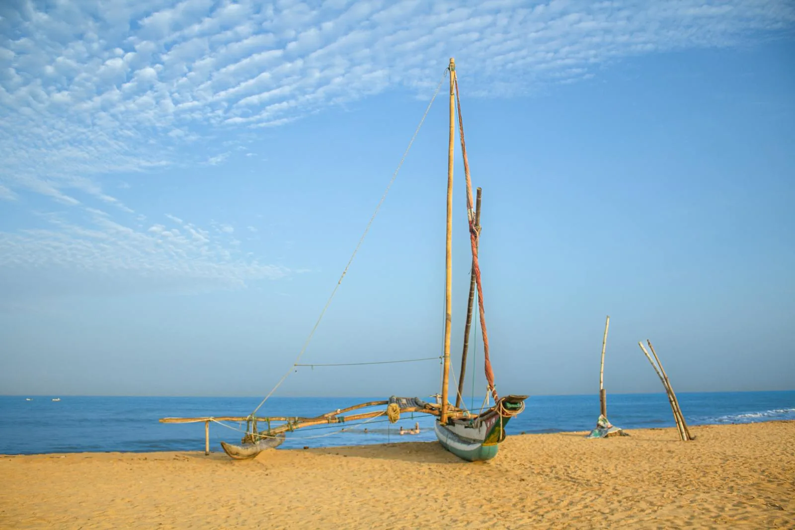 Traditional outrigger fishing boat on the golden sand of Negombo beach, Sri Lanka
